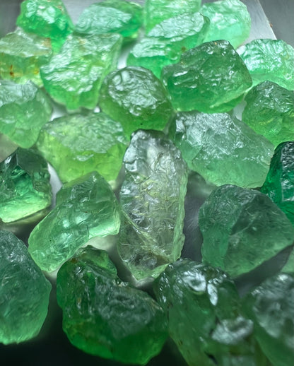 Emerald green kornerupines 168.35 cts / 24 pcs