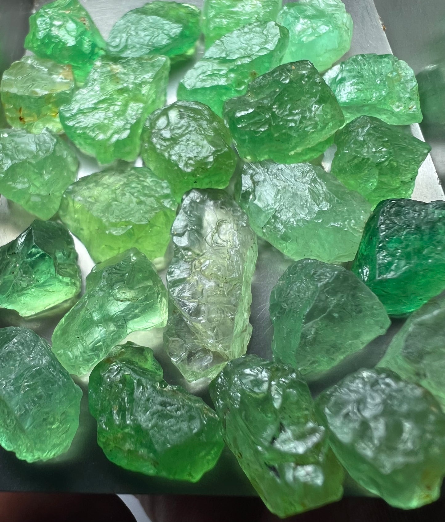 Emerald green kornerupines 168.35 cts / 24 pcs